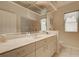 Bright bathroom featuring a large mirror, vanity with marble countertop, and tiled floors at 1429 Blue Jay Ct, Punta Gorda, FL 33950