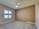 Cozy carpeted bedroom with natural light from the large windows and a ceiling fan at 1429 Blue Jay Ct, Punta Gorda, FL 33950
