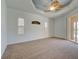 The main bedroom features a ceiling fan, plush carpet, and natural light at 1429 Blue Jay Ct, Punta Gorda, FL 33950