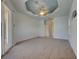 Spacious bedroom features plush carpeting, tray ceiling with fan, and sliding glass doors to the lanai at 1429 Blue Jay Ct, Punta Gorda, FL 33950