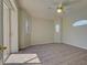 Large bedroom with neutral walls, carpeting, a ceiling fan and access to the lanai at 1429 Blue Jay Ct, Punta Gorda, FL 33950