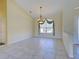Bright dining room featuring tile floors, a chandelier, and large window with decorative valance for natural light at 1429 Blue Jay Ct, Punta Gorda, FL 33950