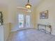 Welcoming foyer with tile flooring, decorative glass doors, and elegant lighting, creating a grand entrance at 1429 Blue Jay Ct, Punta Gorda, FL 33950