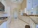 Bright kitchen featuring white cabinets, granite countertops, and stainless steel appliances with seamless flow to other spaces at 1429 Blue Jay Ct, Punta Gorda, FL 33950