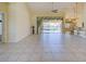 Spacious living room with tile flooring, ceiling fans, and sliding glass doors leading to the outdoor pool area at 1429 Blue Jay Ct, Punta Gorda, FL 33950