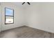 Bright bedroom featuring wood-look tile flooring and large window at 24237 San Lucas Ln, Punta Gorda, FL 33955