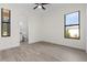 Bedroom with wood-look tile floor, ceiling fan and en-suite bathroom at 24237 San Lucas Ln, Punta Gorda, FL 33955