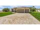 New construction home with paver driveway and landscaped lawn at 24237 San Lucas Ln, Punta Gorda, FL 33955