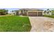 Single-story home with two-car garage, paver driveway, and lush lawn at 24237 San Lucas Ln, Punta Gorda, FL 33955