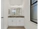 Double vanity bathroom with granite countertop and modern lighting at 24237 San Lucas Ln, Punta Gorda, FL 33955