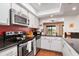 Modern kitchen with stainless steel appliances and granite countertops at 5081 San Rocco Ct, Punta Gorda, FL 33950