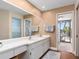 Double vanity bathroom with access to the pool area at 5081 San Rocco Ct, Punta Gorda, FL 33950