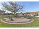 Relaxing community area with benches under a tree at 5081 San Rocco Ct, Punta Gorda, FL 33950