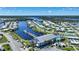 Community aerial view showcasing a marina, waterway access, clubhouse, and swimming pool at 542 Tampico Dr, North Port, FL 34287