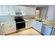 View of kitchen with stainless steel appliances and white cabinets at 66 Wylam Dr, Port Charlotte, FL 33954