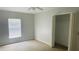 Spacious bedroom with neutral walls, carpeting, a window with blinds, and a closet at 66 Wylam Dr, Port Charlotte, FL 33954