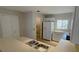 Kitchen with white cabinets, double sink, and view into laundry room at 66 Wylam Dr, Port Charlotte, FL 33954