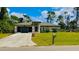 Single-story house with gray roof, double garage, and manicured lawn at 66 Wylam Dr, Port Charlotte, FL 33954