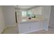 Kitchen with white cabinets, stainless steel appliances, and light flooring at 66 Wylam Dr, Port Charlotte, FL 33954