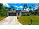 Aerial view of house, driveway, and landscaping at 66 Wylam Dr, Port Charlotte, FL 33954