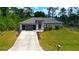 Aerial view of house, driveway, and landscaping at 66 Wylam Dr, Port Charlotte, FL 33954