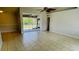 Living room with tile floors, sliding glass doors, and a ceiling fan at 66 Wylam Dr, Port Charlotte, FL 33954