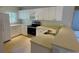 Kitchen with light wood cabinets, stainless steel appliances, and an island at 66 Wylam Dr, Port Charlotte, FL 33954