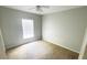 Bright bedroom featuring a large window and ceiling fan at 66 Wylam Dr, Port Charlotte, FL 33954