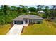 Single-Gathering home with a two-car garage and landscaped yard at 66 Wylam Dr, Port Charlotte, FL 33954