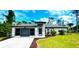 Single-story home with a two-car garage and well-maintained landscaping at 66 Wylam Dr, Port Charlotte, FL 33954