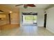 Living room with tile floors, sliding glass doors, and a ceiling fan at 66 Wylam Dr, Port Charlotte, FL 33954