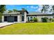 Single-story home with a two-car garage and well-maintained landscaping at 66 Wylam Dr, Port Charlotte, FL 33954