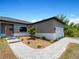 Single-story house with gray siding and paver walkway at 14242 Imlay Ave, Port Charlotte, FL 33981