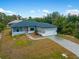 Aerial view of a single-story house with paver driveway and landscaping at 14242 Imlay Ave, Port Charlotte, FL 33981
