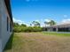 Large backyard with grassy area and view of a screened pool area at 14242 Imlay Ave, Port Charlotte, FL 33981