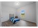 Small bedroom with a twin-sized bed and a large window at 14242 Imlay Ave, Port Charlotte, FL 33981