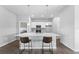 Modern kitchen with white cabinets and island with seating at 14242 Imlay Ave, Port Charlotte, FL 33981