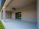 Covered patio with a ceiling fan and sliding glass door at 14242 Imlay Ave, Port Charlotte, FL 33981