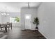 Light and airy entryway with tile floors and plant at 14242 Imlay Ave, Port Charlotte, FL 33981