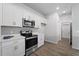 Modern kitchen with white cabinets and stainless steel appliances at 14242 Imlay Ave, Port Charlotte, FL 33981