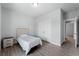 Small bedroom with a twin bed and gray floors at 13409 Warba Ave, Port Charlotte, FL 33981