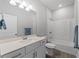 Clean bathroom with white vanity, bathtub, and tile flooring at 13409 Warba Ave, Port Charlotte, FL 33981