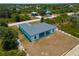 Aerial view of a new single-Gathering home with a gray roof and attached garage at 13409 Warba Ave, Port Charlotte, FL 33981