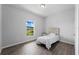 Bright bedroom with a twin bed and gray floors at 13409 Warba Ave, Port Charlotte, FL 33981