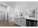 Modern kitchen with white cabinets, quartz countertops, and stainless steel appliances at 13409 Warba Ave, Port Charlotte, FL 33981