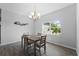 Bright dining room features a grey table and chandelier at 13409 Warba Ave, Port Charlotte, FL 33981