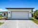 White garage door with a gray paver driveway at 13409 Warba Ave, Port Charlotte, FL 33981