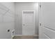 Laundry room with shelving and a door for extra storage at 13409 Warba Ave, Port Charlotte, FL 33981