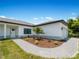 Exterior view of a new home with a gray roof, white siding, and landscaped yard at 13409 Warba Ave, Port Charlotte, FL 33981