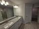Double vanity bathroom with granite countertops and walk-in shower at 4051 Dotham St, Port Charlotte, FL 33948